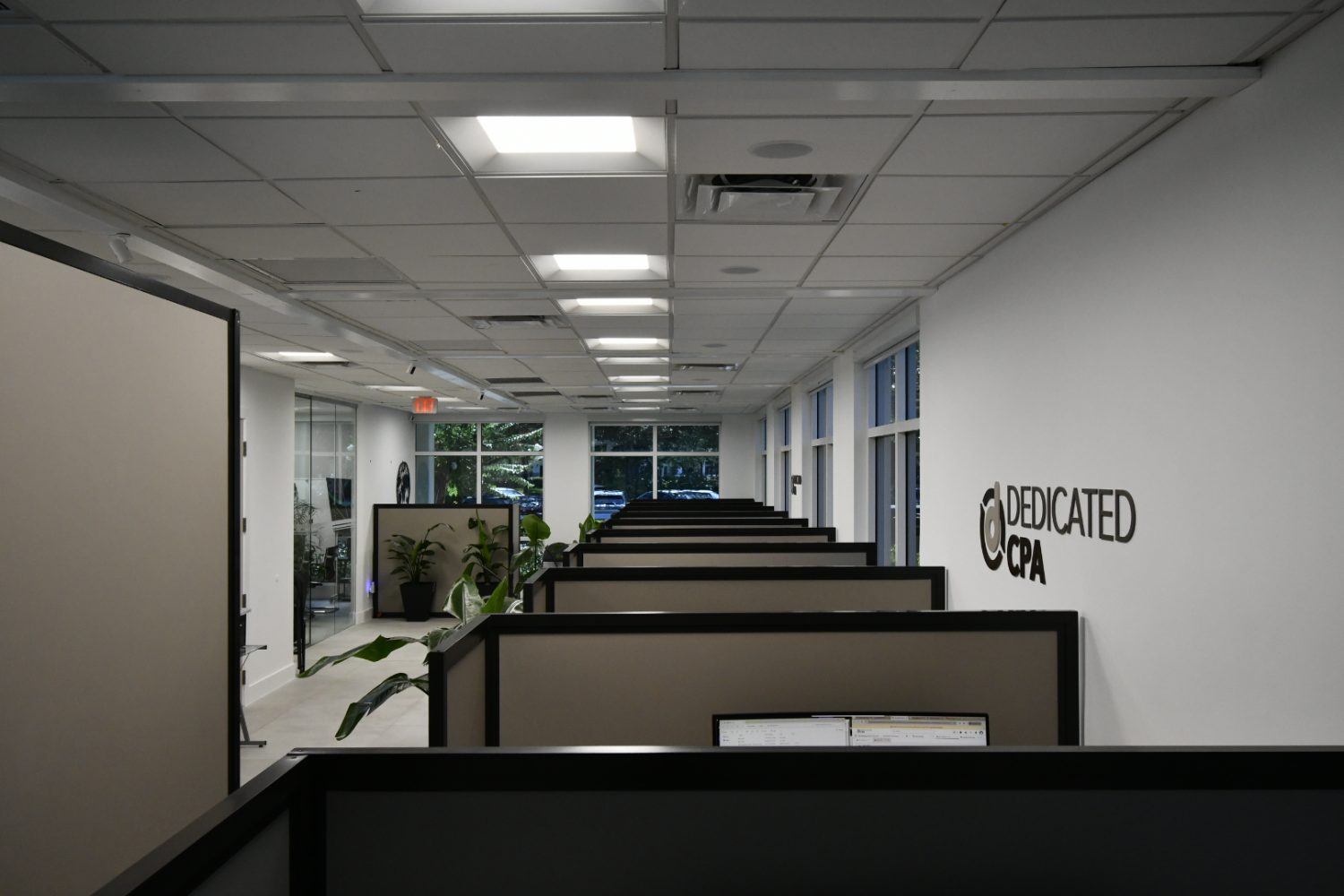 Open-plan workspace with the Dedicated CPA sign